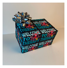 photograph of the wrapping paper in context, a present with a silver bow wrapped in the designed paper sits among a white background